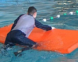 pool lifeguard swimming in uniform clothes